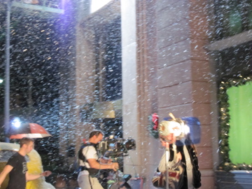 fake snow spraying on a blacl lot set